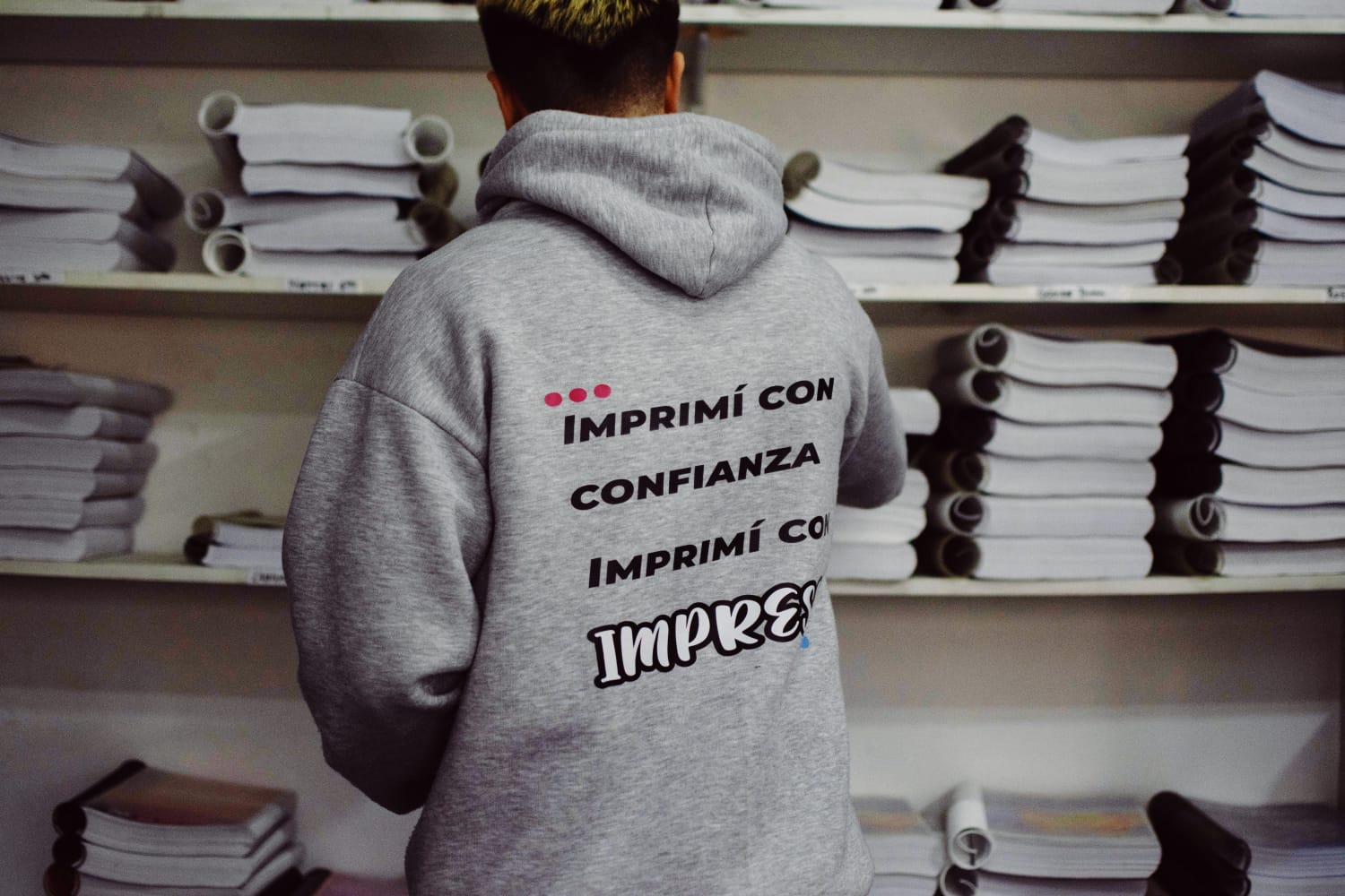 Equipo de Impress entre pilas de apuntes